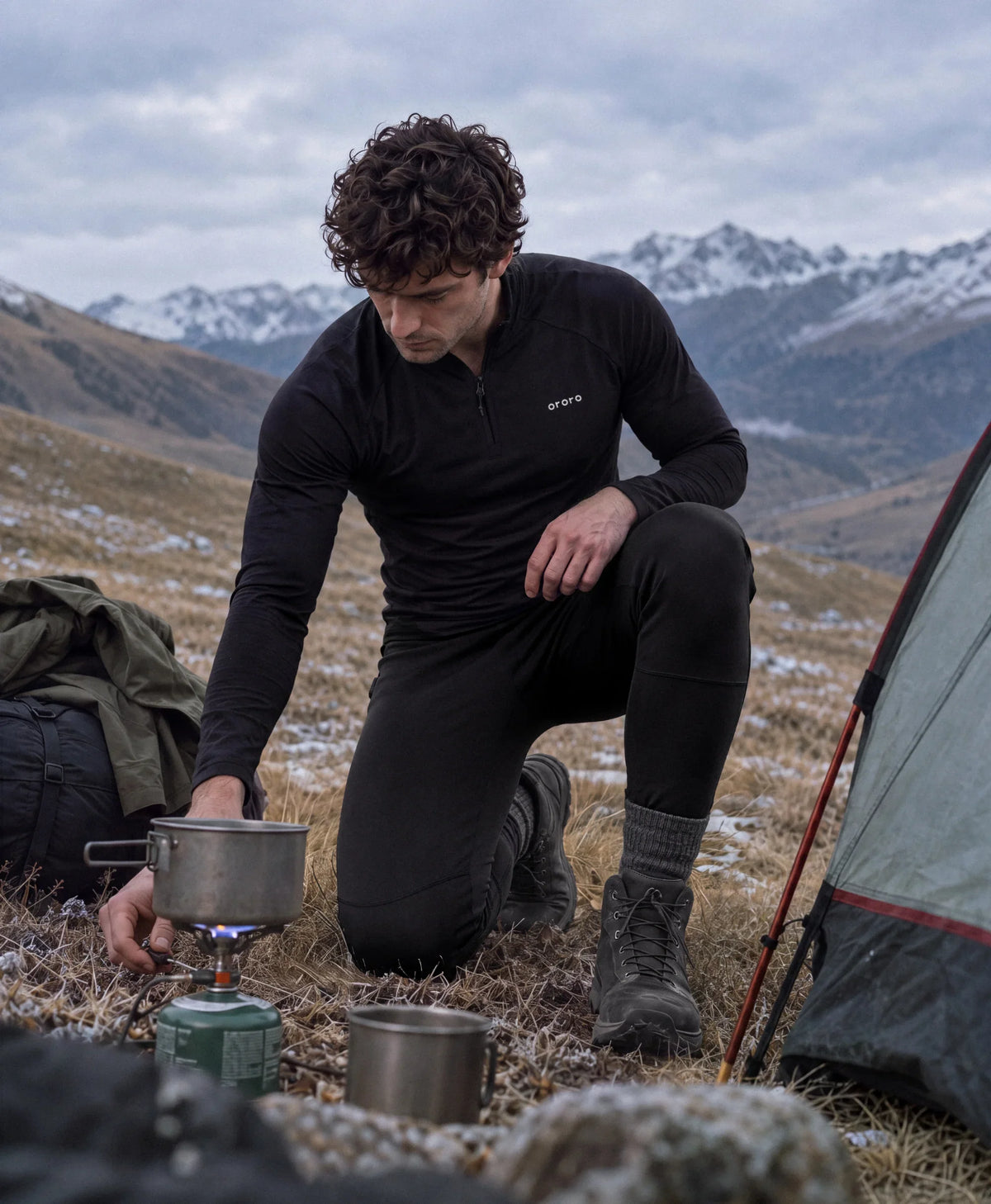 Man wearing ororo heated baselayers at mountain campsite