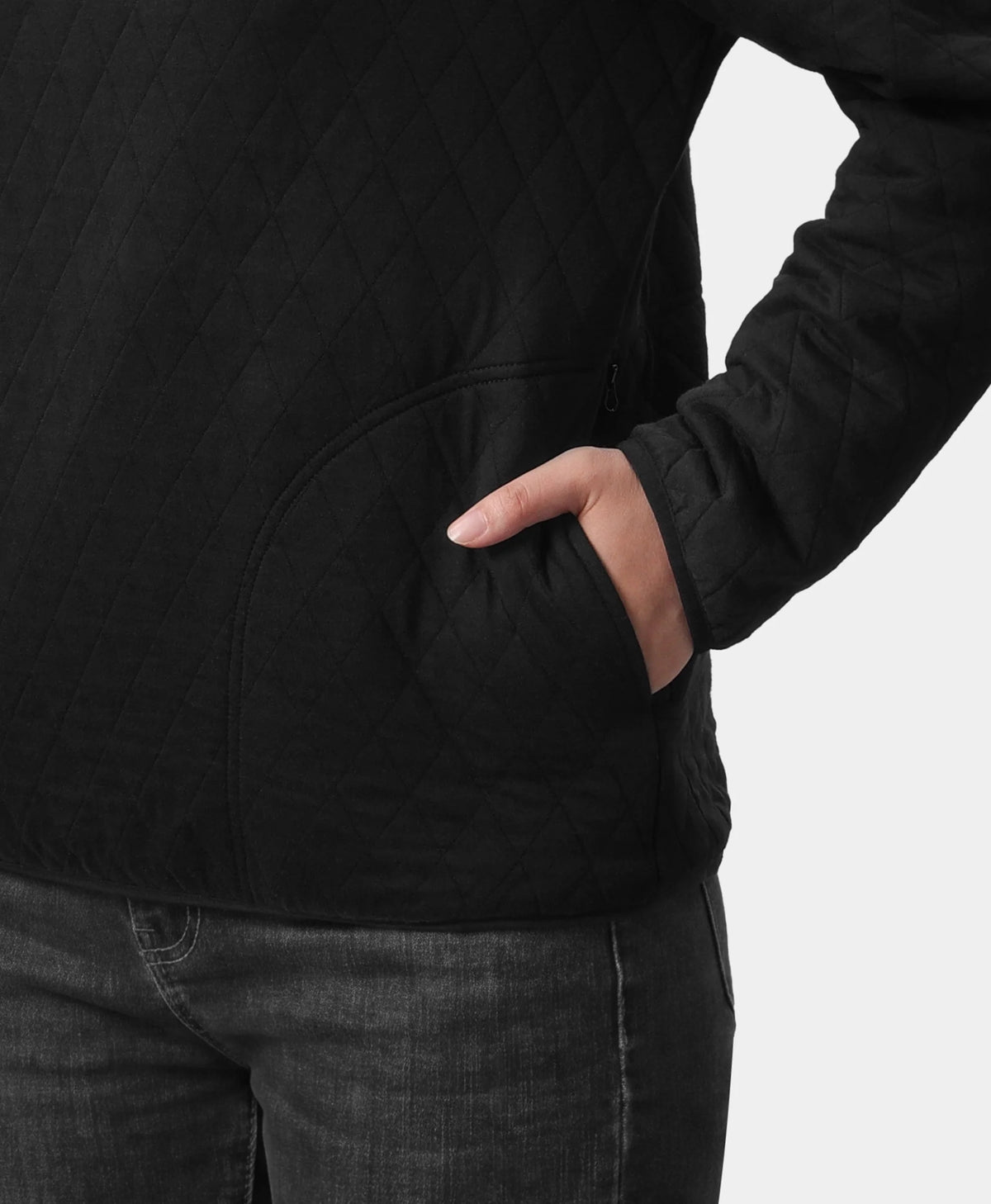 Close-up of a hand placed in the pocket of an ororo black quilted heated jacket.