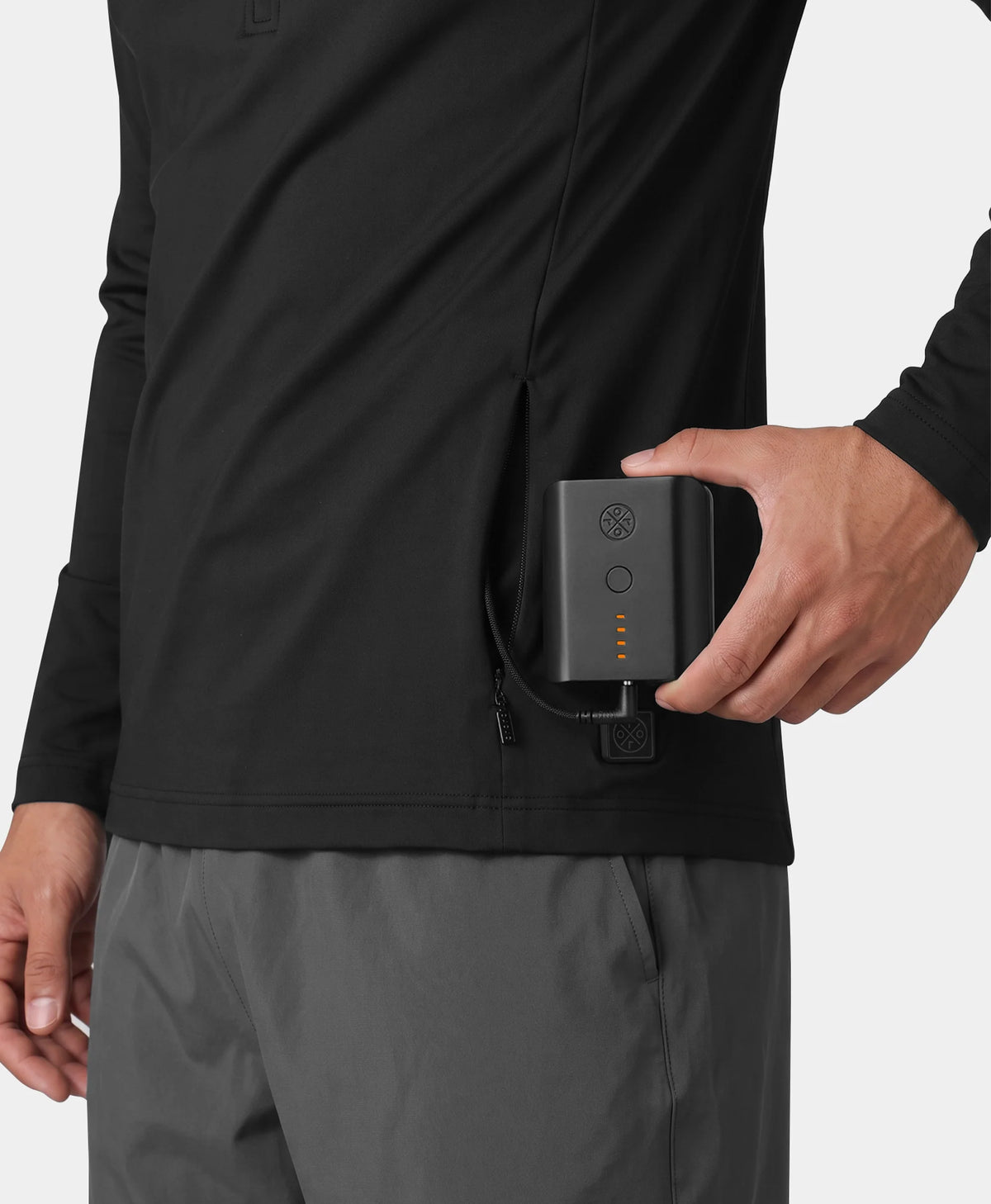 Close-up of a man putting a battery pack into the zippered side pocket of an ororo black heated base layer top.