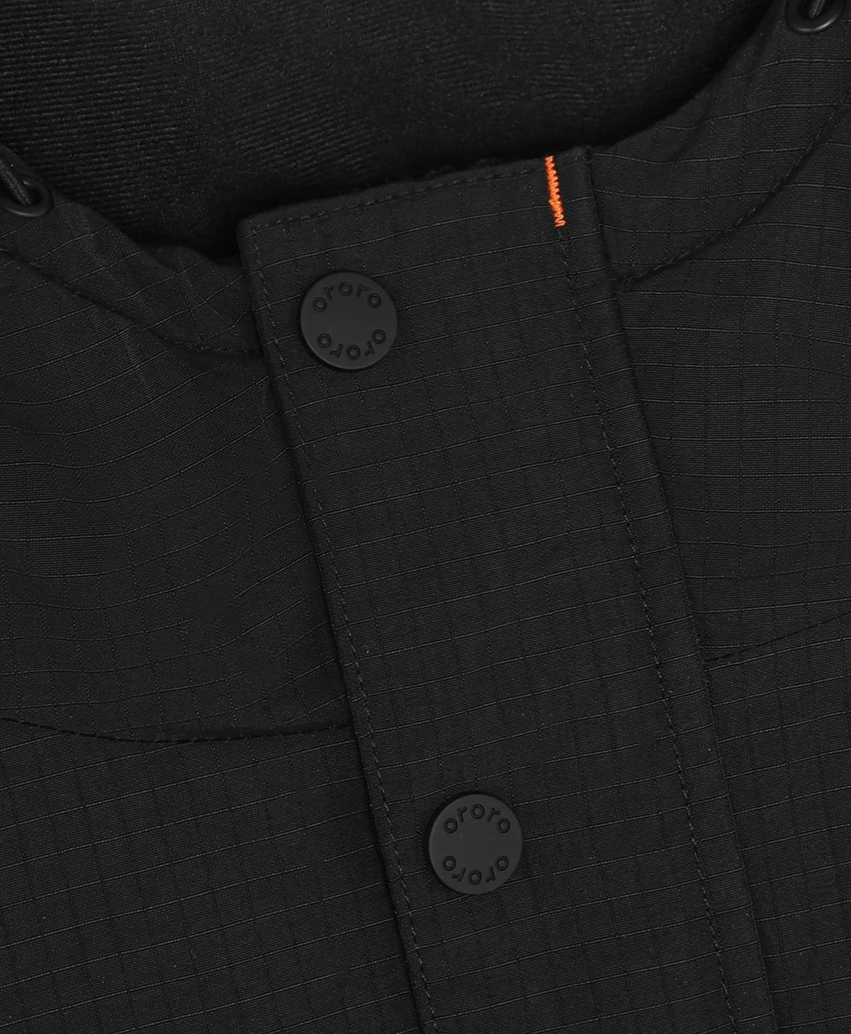 Close-up of a black textured ororo heated jacket with a buttoned collar, black buttons