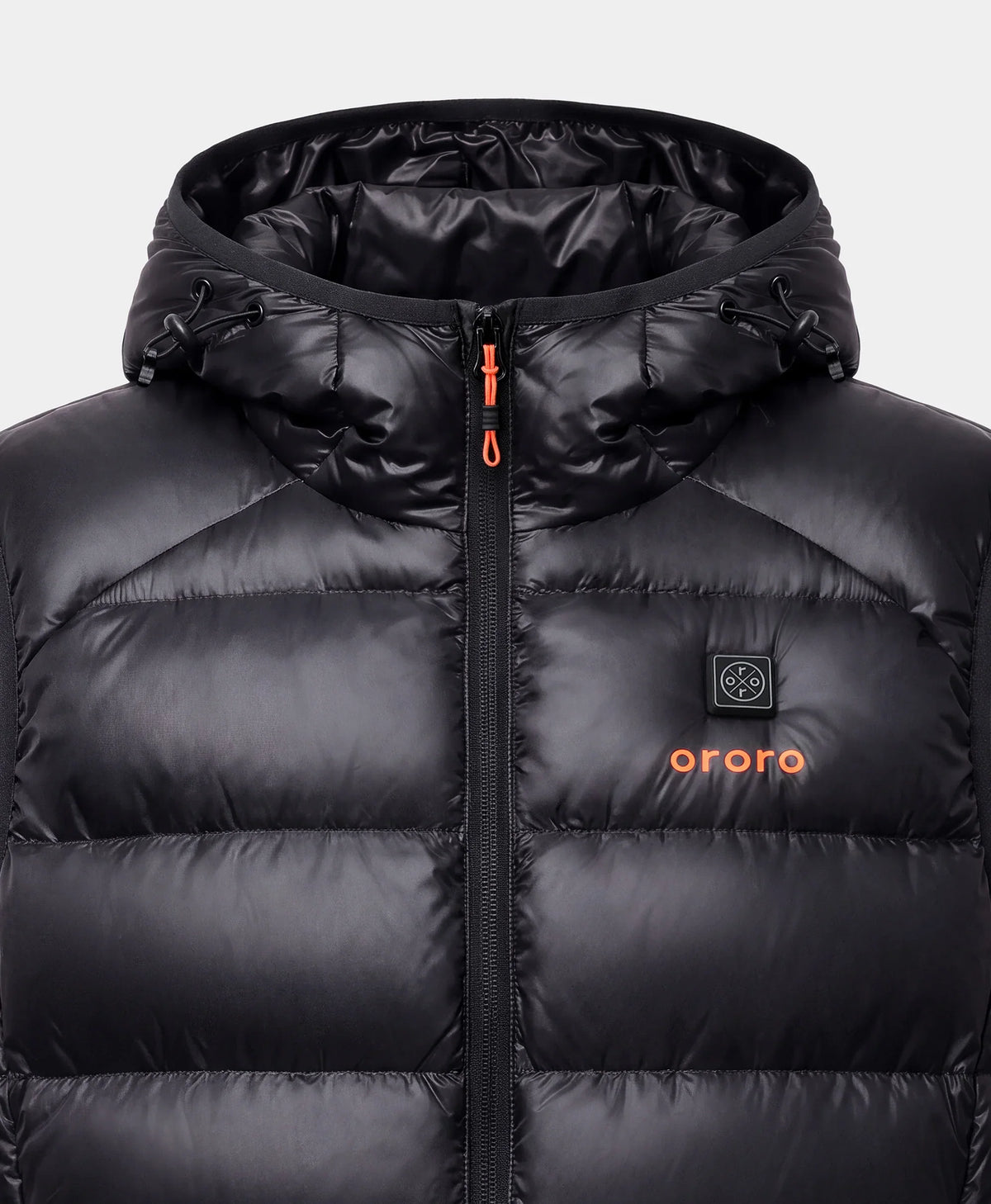 Close-up front view of a black hooded down vest with a power button on the chest